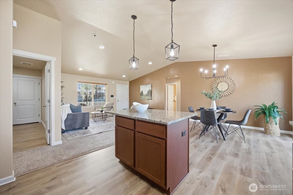 3709 Morehouse Place Pasco, WA 99301 - Photo 18 of 32 a living room with furniture a dining table and chairs