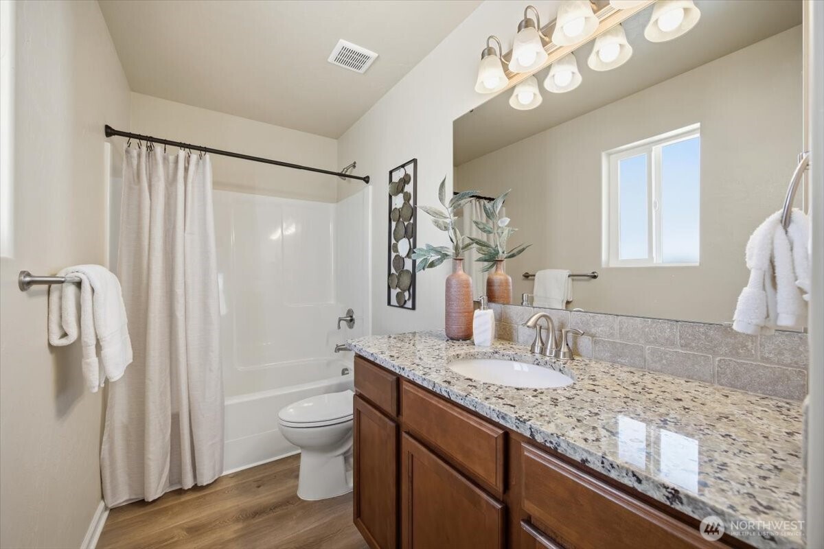 3709 Morehouse Place Pasco, WA 99301 - Photo 24 of 32 a bathroom with a granite countertop sink a toilet and a large mirror