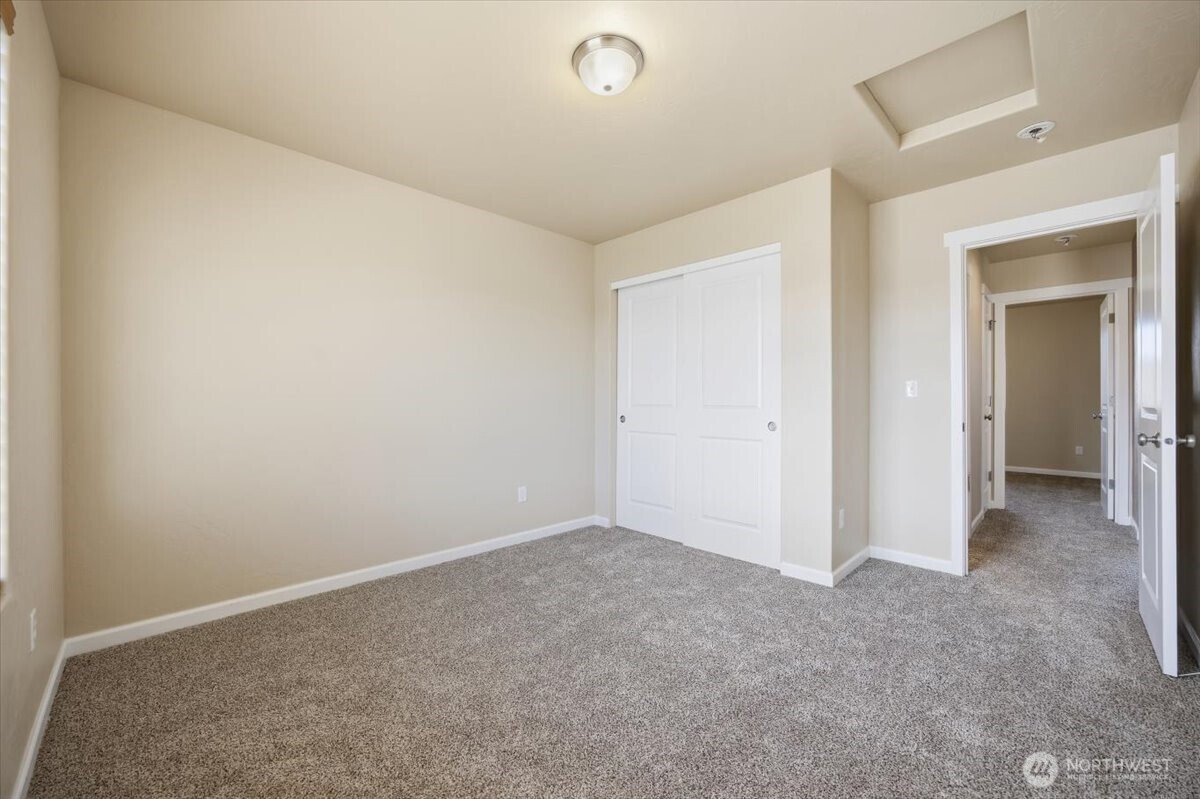 3709 Morehouse Place Pasco, WA 99301 - Photo 27 of 32 an empty room with closet and a chandelier fan