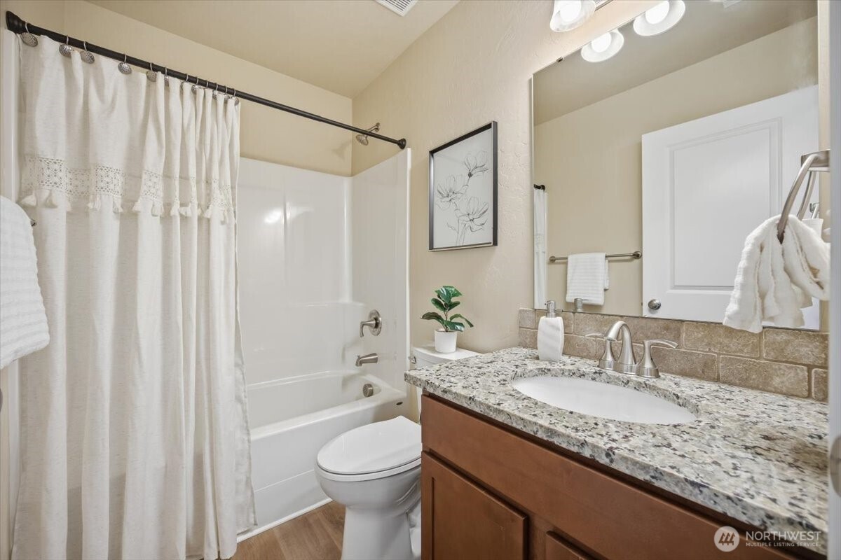 3709 Morehouse Place Pasco, WA 99301 - Photo 28 of 32 a bathroom with a granite countertop sink and a mirror a toilet
