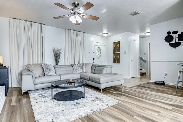 a living room with furniture and a chandelier