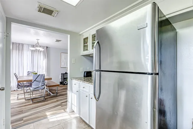 a kitchen with stainless steel appliances a refrigerator and a fireplace