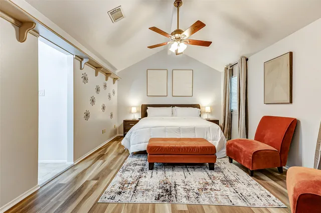 a bedroom with furniture and wooden floor