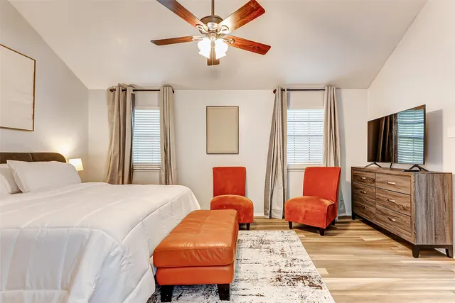 a bedroom with furniture and a flat screen tv