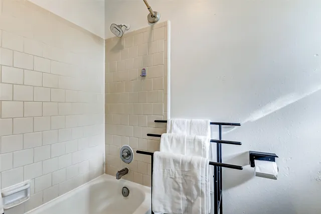a bathroom with a bathtub and shower