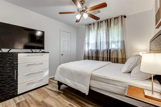 a bedroom with a bed and a flat screen tv
