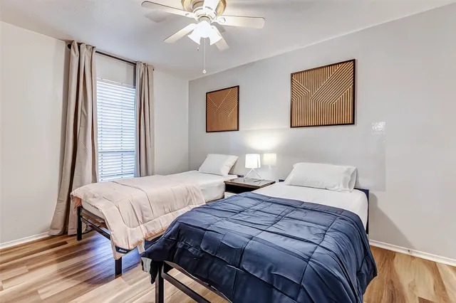 a bedroom with two beds and a chandelier
