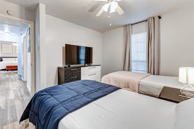 a bedroom with a bed and a flat screen tv