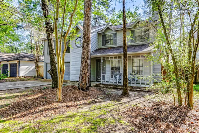 a tree in front of a house