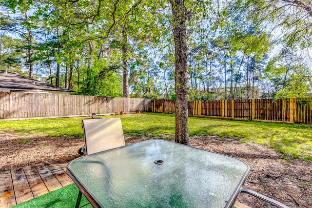 a view of a backyard with wooden fence