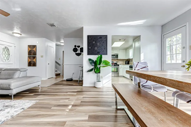 a living room with furniture and wooden floor