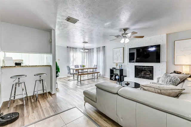 a living room with furniture a fireplace and a flat screen tv