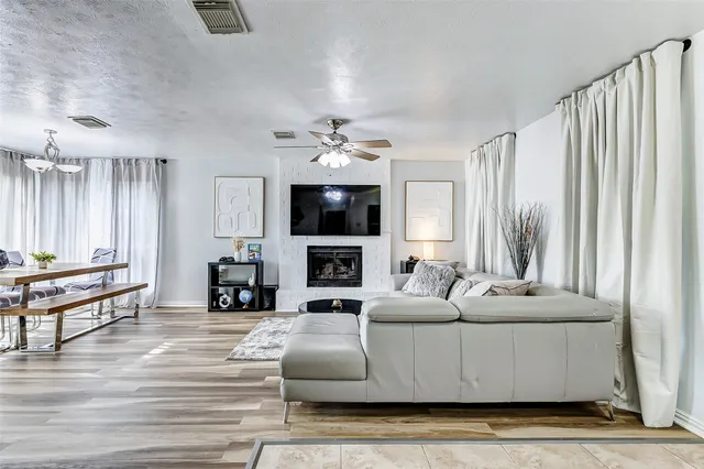 a living room with fireplace furniture and a flat screen tv