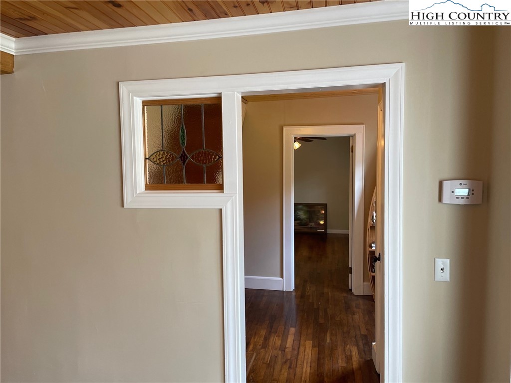 3350 Teaberry Road Lansing, NC 28643 - Photo 17 of 30 a view of a hallway with wooden floor and a living room