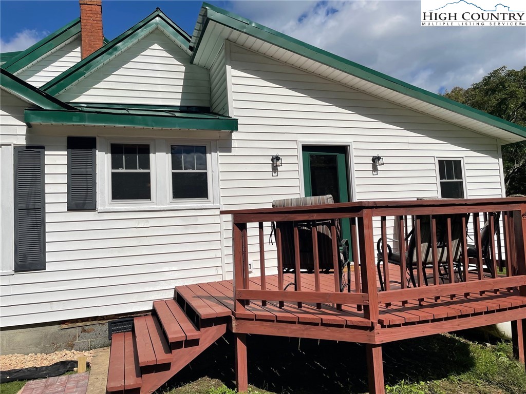 3350 Teaberry Road Lansing, NC 28643 - Photo 3 of 30 a view of a house with wooden deck and furniture