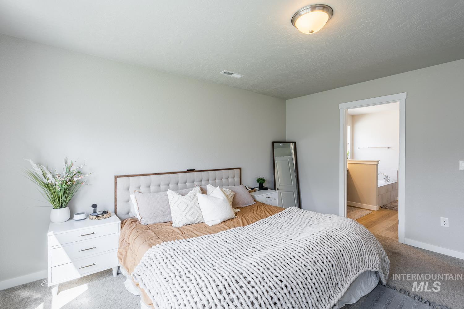 12623 Shadow Peak Street Caldwell, ID 83607 - Photo 28 of 50 Carpeted room with light gray walls and a tray ceiling