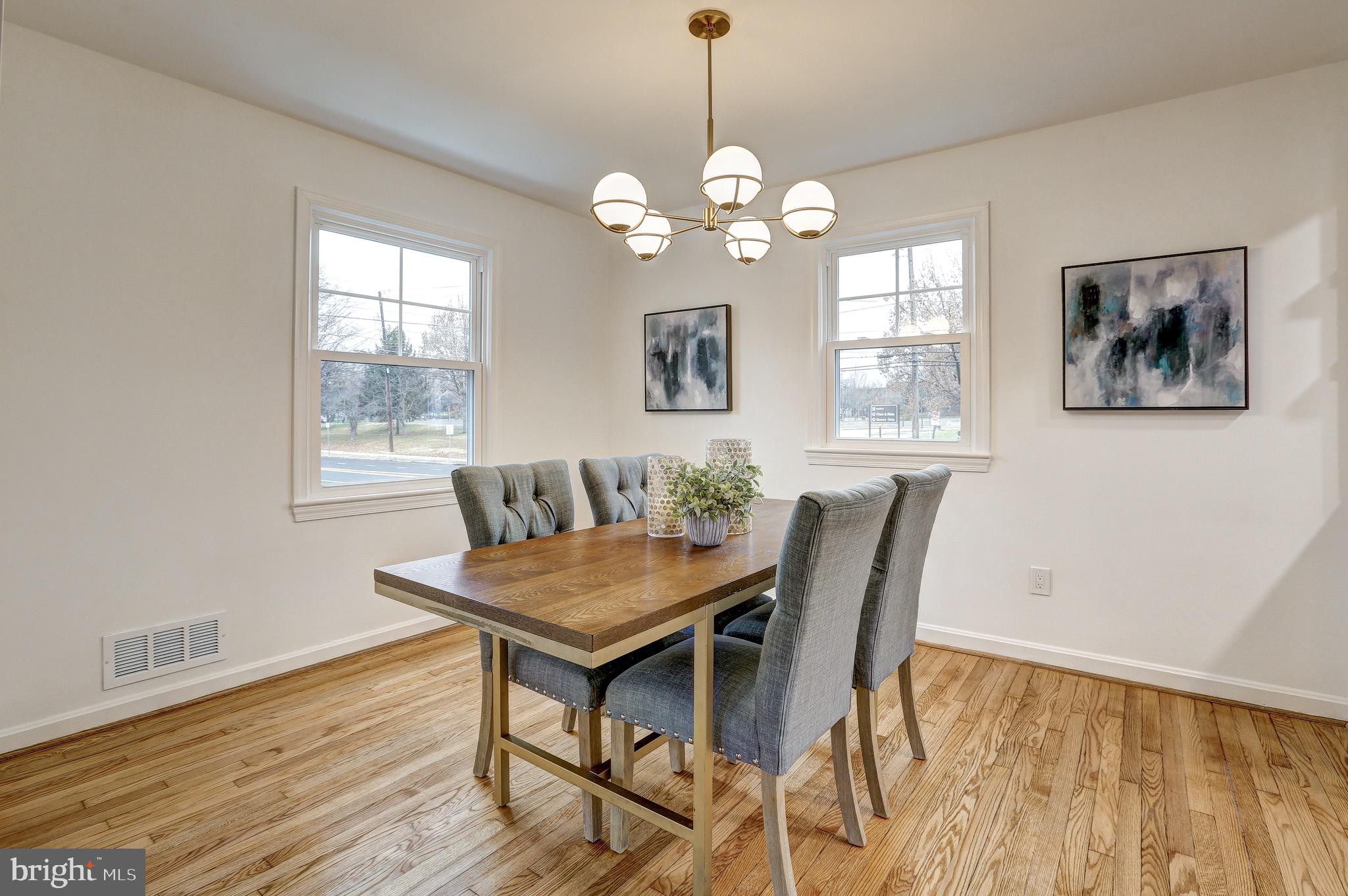 2116 Forest Glen Road Silver Spring, MD 20910 - Photo 11 of 57 a dining room with wooden floor and a chandelier