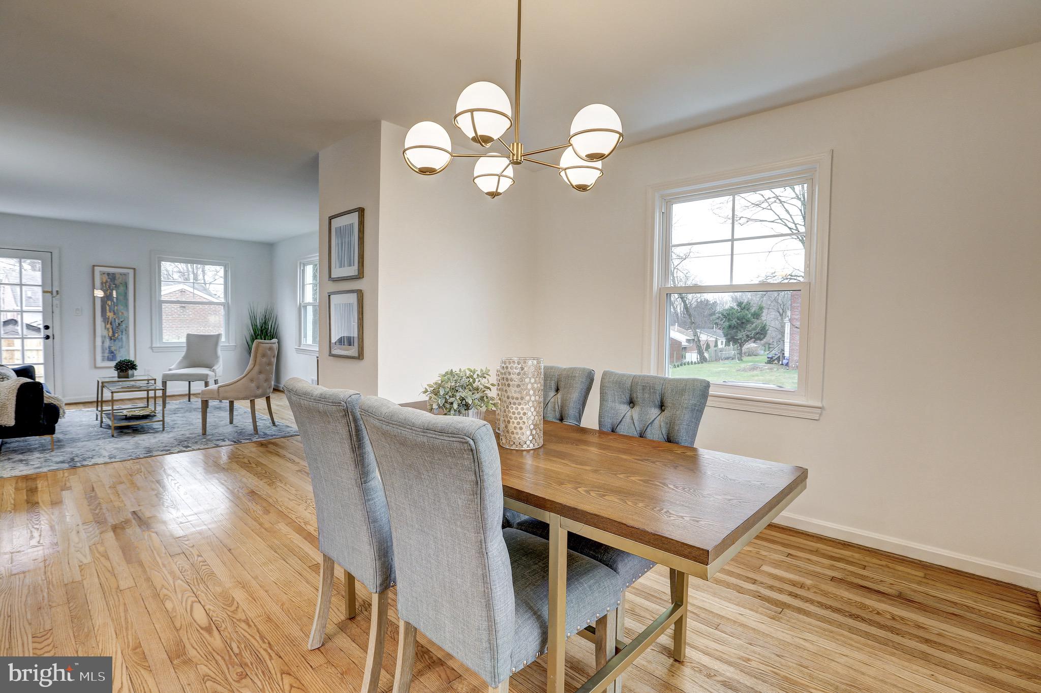 2116 Forest Glen Road Silver Spring, MD 20910 - Photo 14 of 57 a view of a dining room with furniture a chandelier and wooden floor