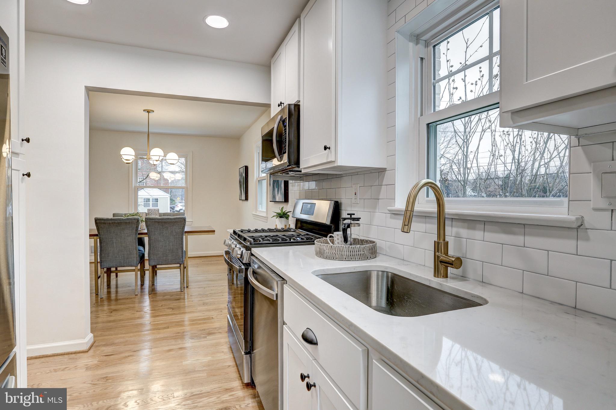 2116 Forest Glen Road Silver Spring, MD 20910 - Photo 18 of 57 a kitchen with granite countertop a sink a counter top space cabinets and stainless steel appliances