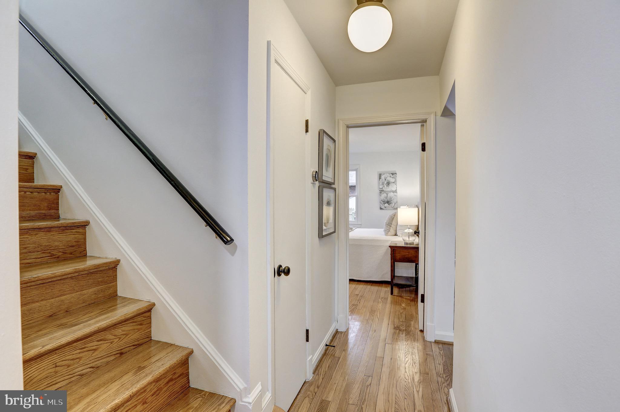 2116 Forest Glen Road Silver Spring, MD 20910 - Photo 20 of 57 a view of a hallway with wooden floor and staircase