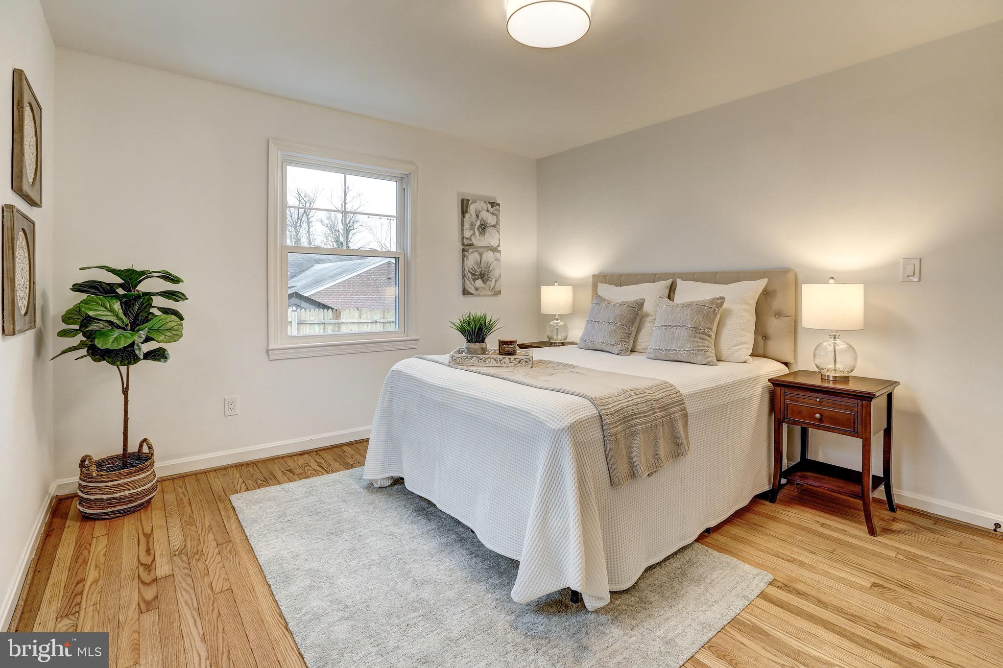 2116 Forest Glen Road Silver Spring, MD 20910 - Photo 22 of 57 a bedroom with a bed and a potted plant