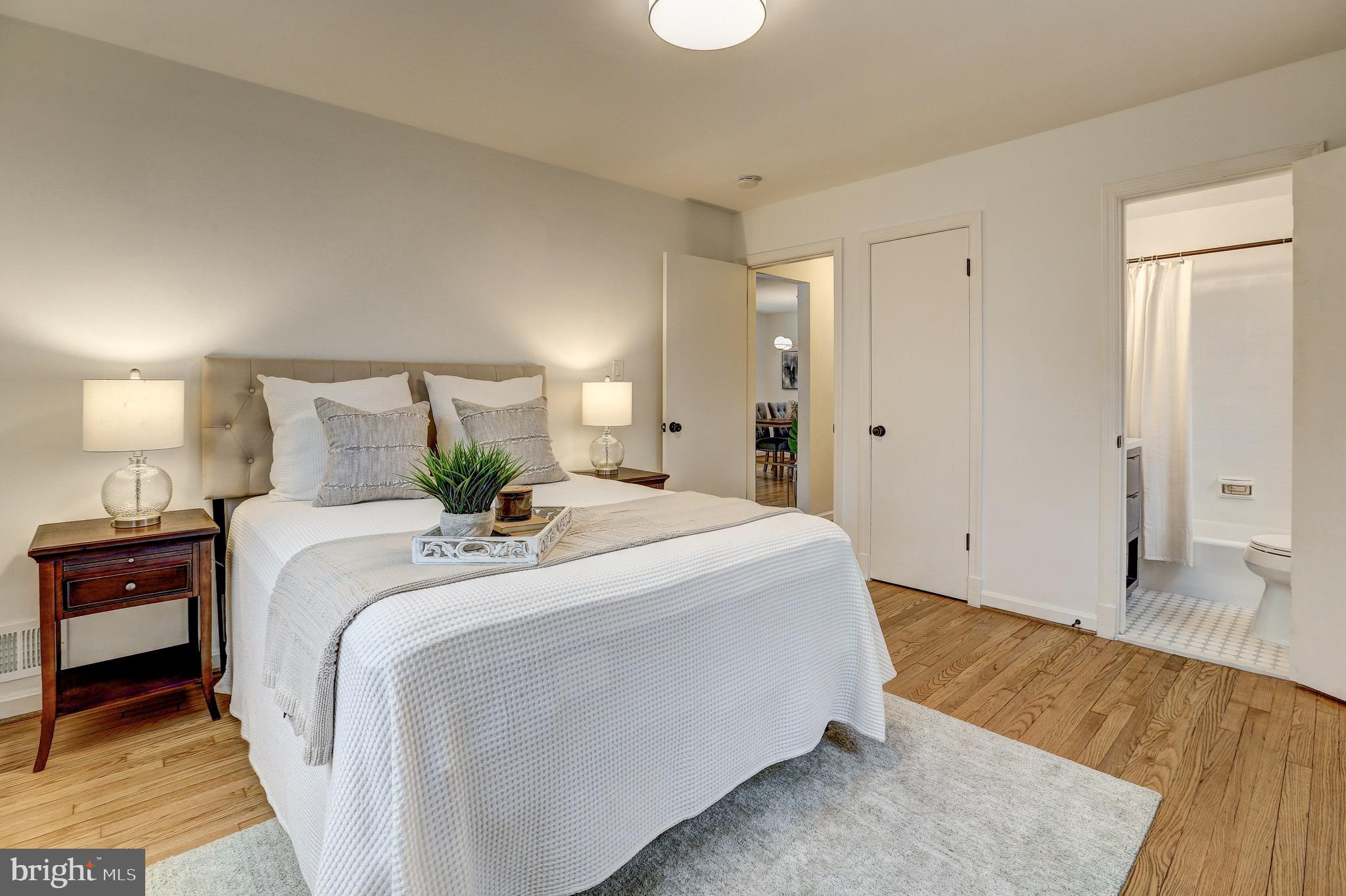 2116 Forest Glen Road Silver Spring, MD 20910 - Photo 23 of 57 a spacious bedroom with a bed and a wooden floor