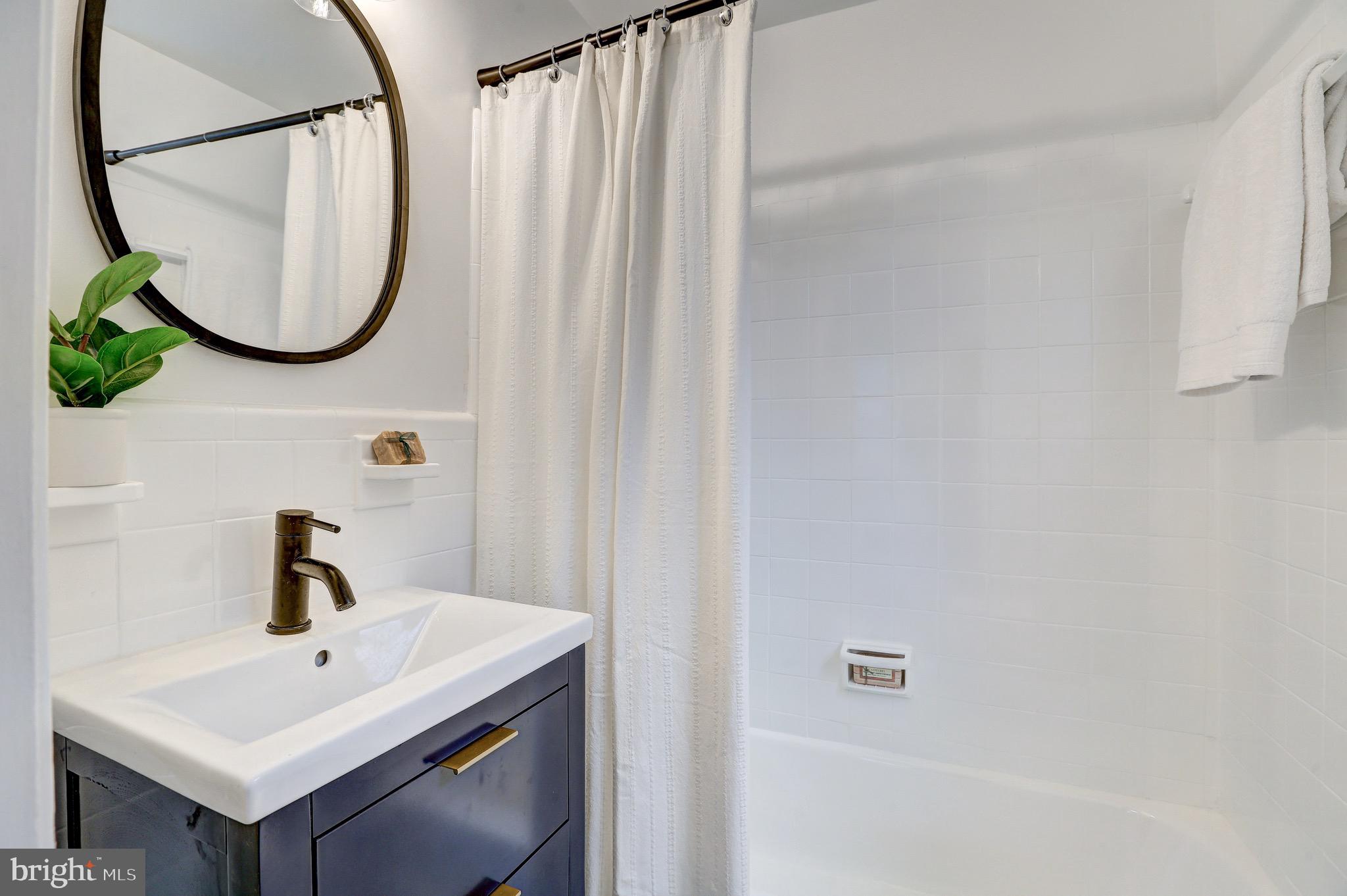 2116 Forest Glen Road Silver Spring, MD 20910 - Photo 24 of 57 a bathroom with a sink and a mirror