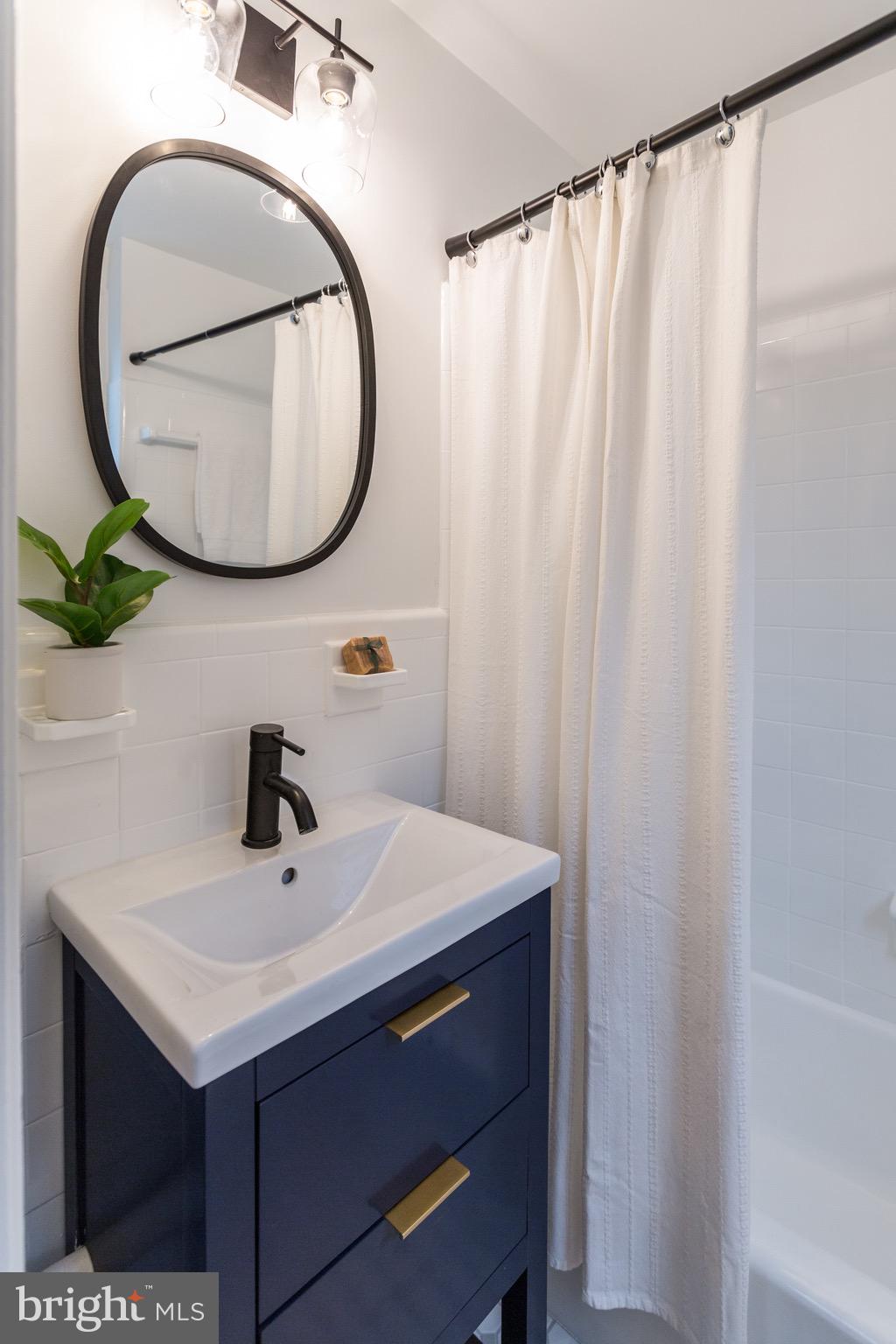2116 Forest Glen Road Silver Spring, MD 20910 - Photo 25 of 57 a bathroom with a sink and a mirror