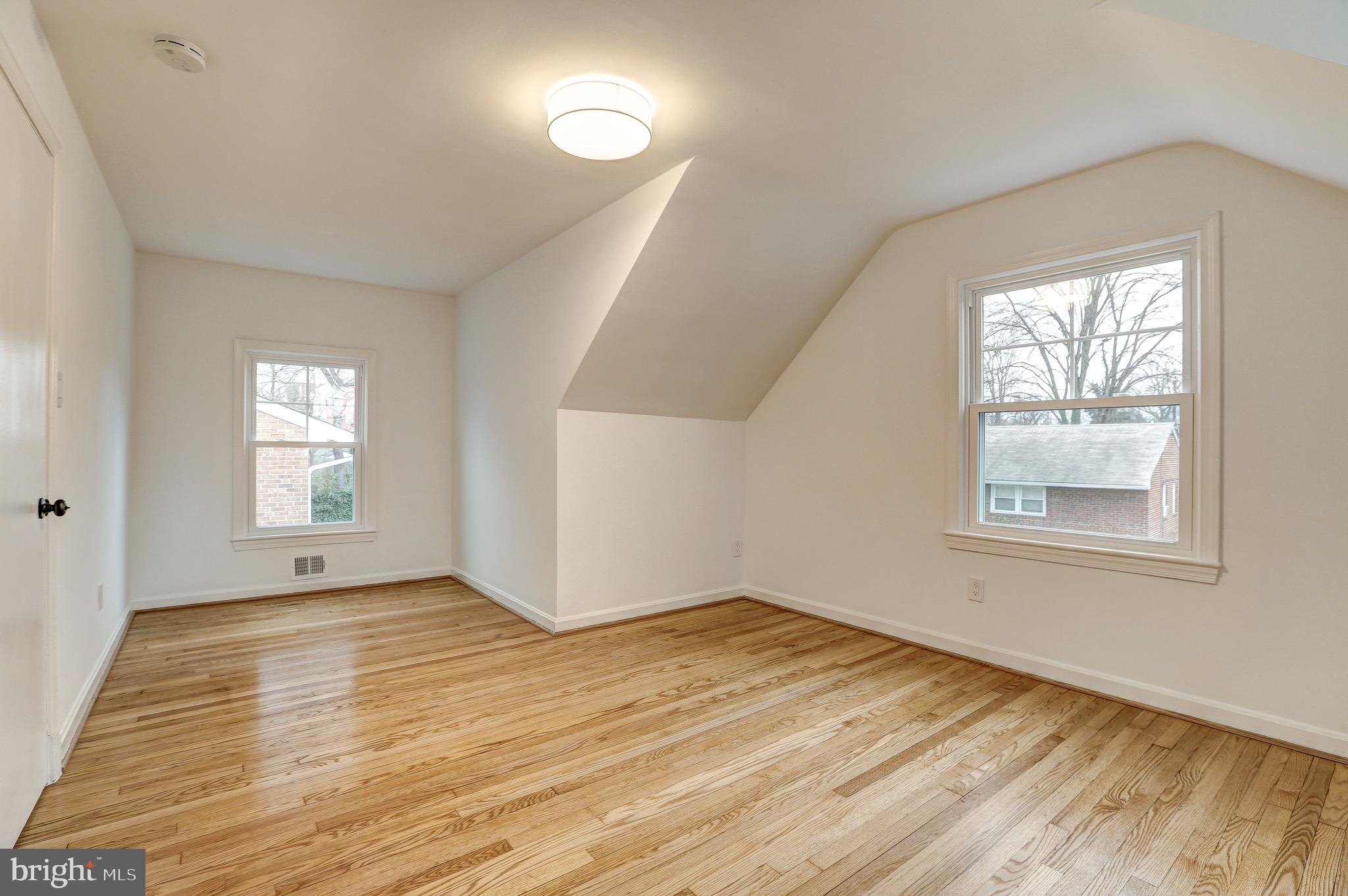 2116 Forest Glen Road Silver Spring, MD 20910 - Photo 27 of 57 an empty room with wooden floor and windows