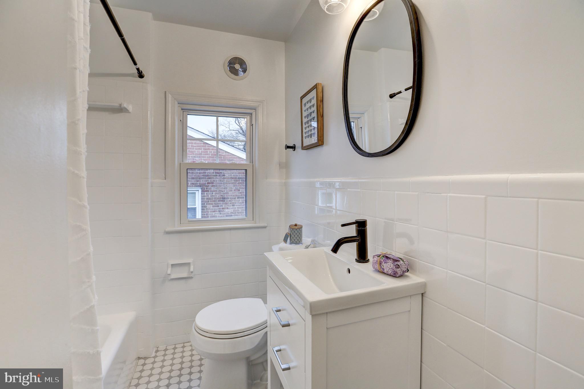 2116 Forest Glen Road Silver Spring, MD 20910 - Photo 33 of 57 a bathroom with a toilet sink and mirror