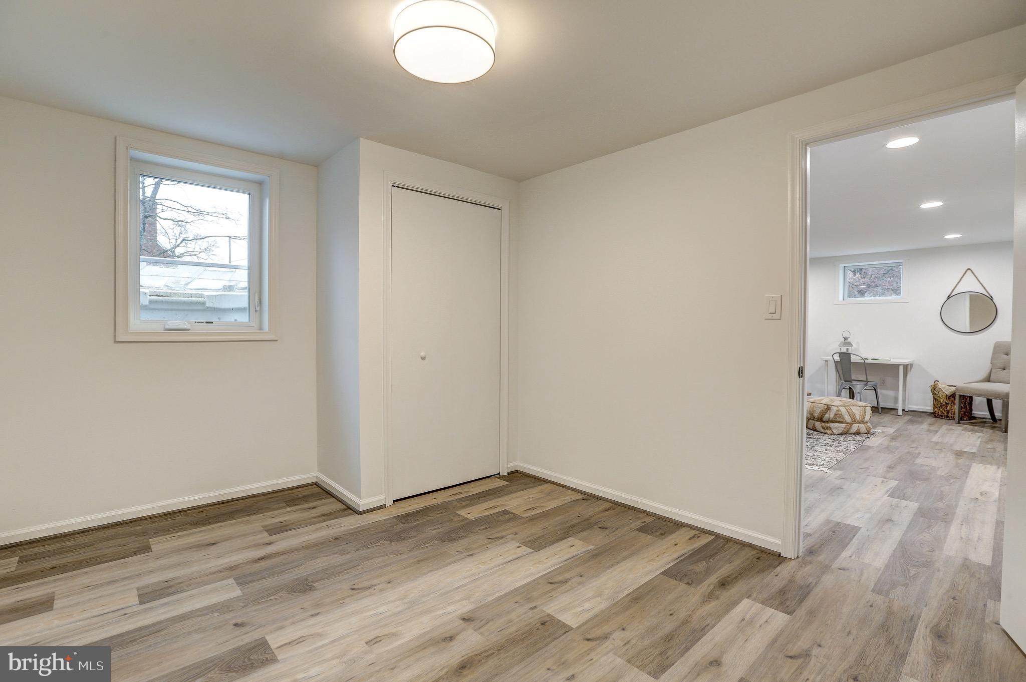2116 Forest Glen Road Silver Spring, MD 20910 - Photo 46 of 57 an empty room with wooden floor and windows