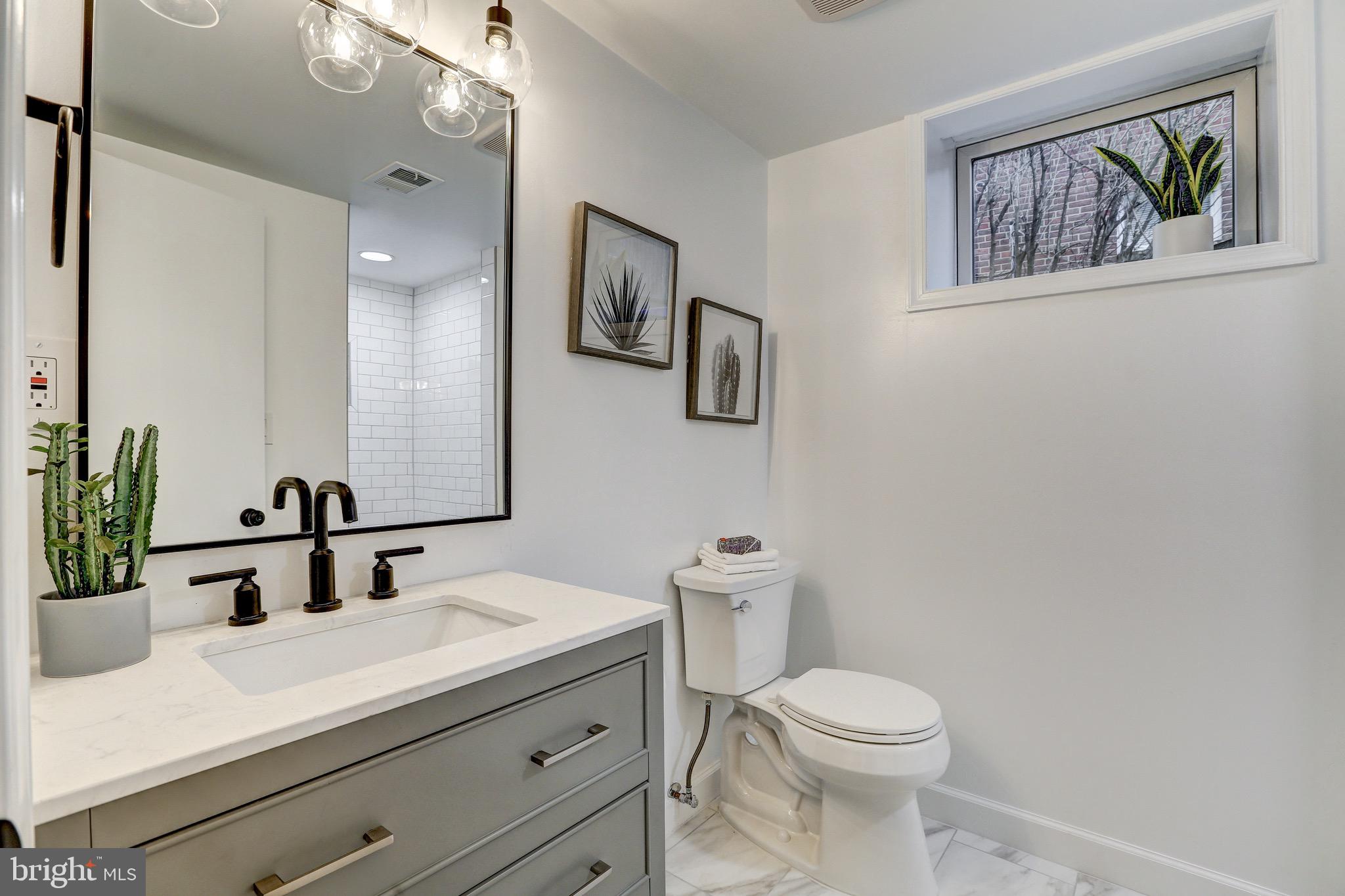2116 Forest Glen Road Silver Spring, MD 20910 - Photo 47 of 57 a bathroom with a toilet a sink and mirror