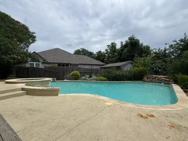 a view of a house with swimming pool and sitting area