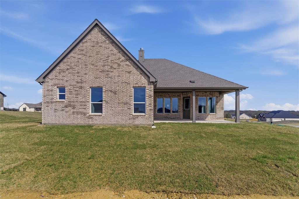 814 Vly Rdg Road Van Alstyne, TX 75495 - Photo 21 of 24 a front view of a house with a garden and deck