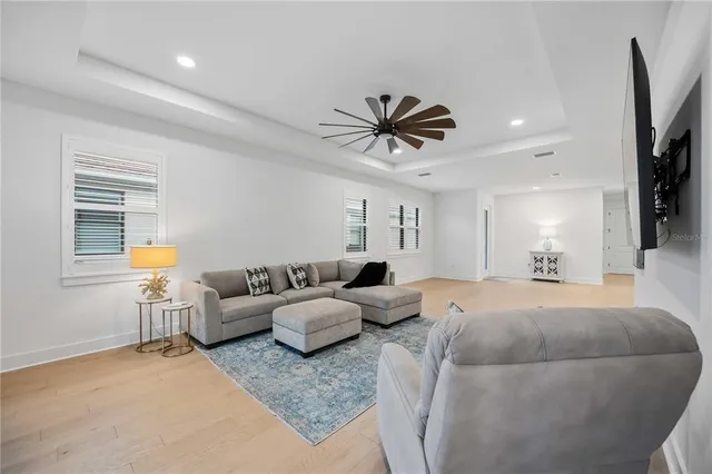 a kitchen with stainless steel appliances granite countertop a sink a stove a refrigerator cabinets and chairs