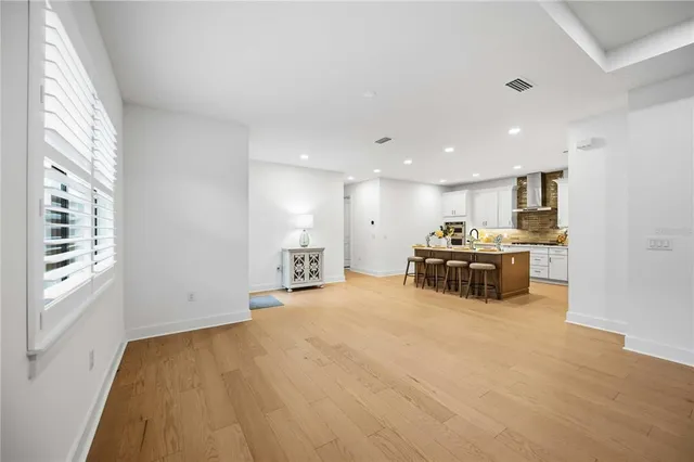a kitchen with white cabinets stainless steel appliances and sink