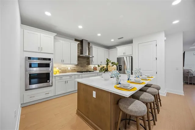 a bathroom with a bathtub sink mirror vanity and toilet