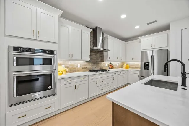 a view of a room with furniture and wooden floor