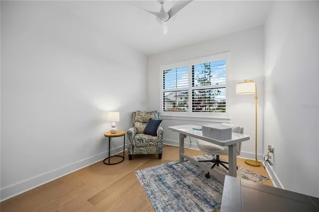 an aerial view of residential houses with outdoor space and ocean view