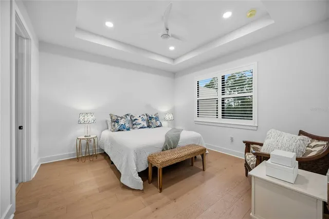 an aerial view of residential houses with outdoor space and ocean view