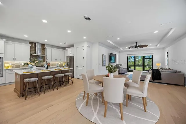 a view of a dining room with furniture and a kitchen