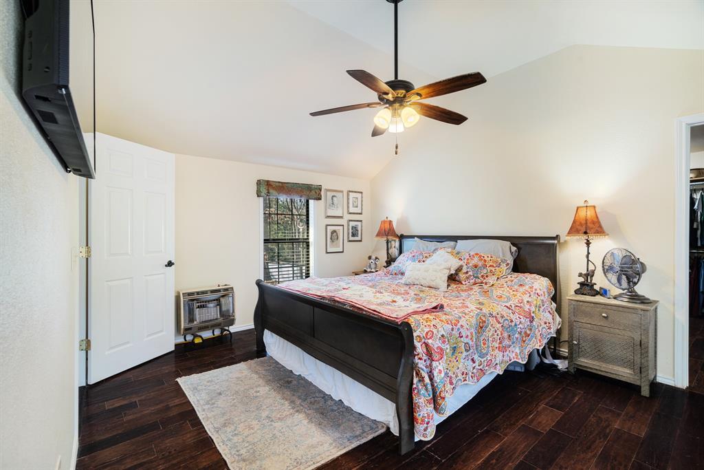 1431 County Road Paris, TX 75462 - Photo 11 of 27 a bedroom with a bed and a chandelier