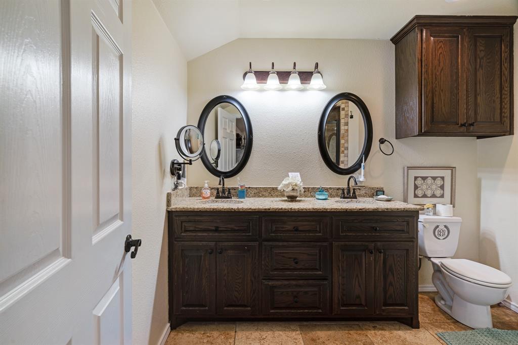 1431 County Road Paris, TX 75462 - Photo 12 of 27 a bathroom with a toilet a sink and a mirror
