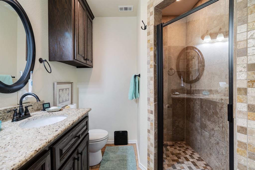 1431 County Road Paris, TX 75462 - Photo 13 of 27 a bathroom with a granite countertop sink a mirror and a shower