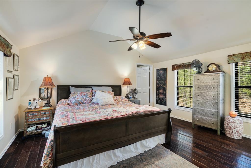 1431 County Road Paris, TX 75462 - Photo 10 of 27 a bedroom with a large bed and a chandelier
