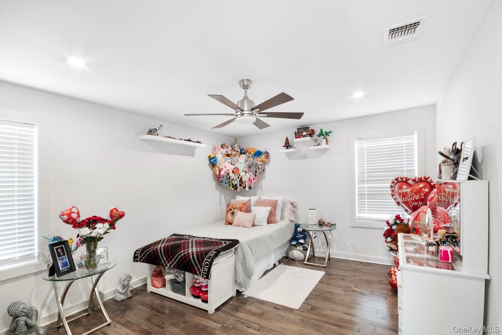 65 Doane Avenue Bellport, NY 11713 - Photo 17 of 37 a living room with furniture and flowers