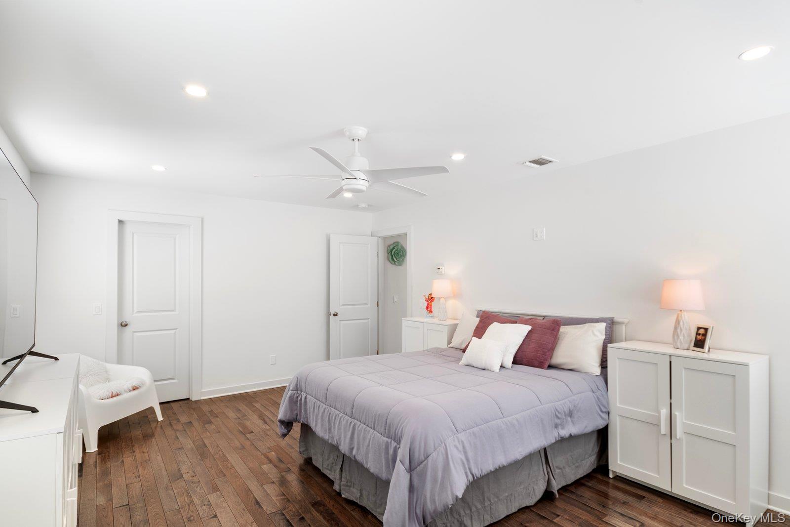 65 Doane Avenue Bellport, NY 11713 - Photo 20 of 37 a bedroom with a bed and a table