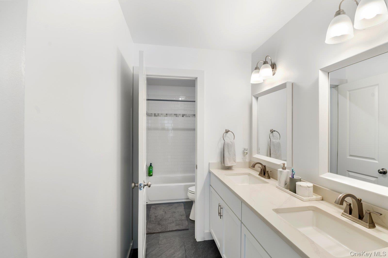 65 Doane Avenue Bellport, NY 11713 - Photo 24 of 37 a bathroom with a double vanity sink mirror and double