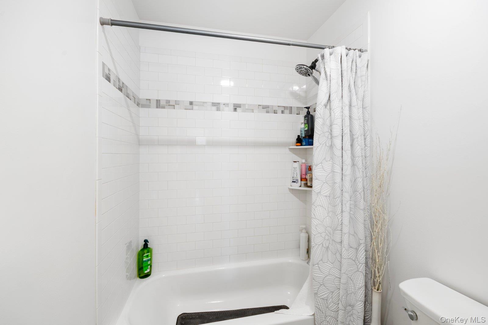 65 Doane Avenue Bellport, NY 11713 - Photo 25 of 37 a bathroom with a shower and a bath tub