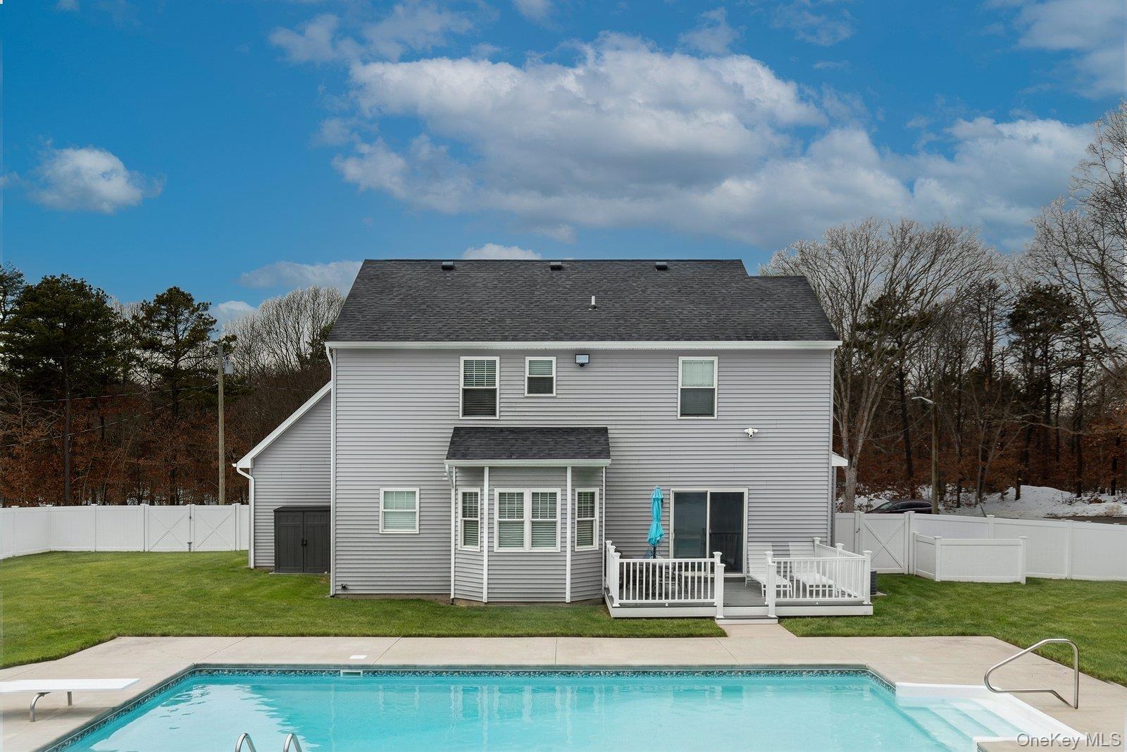 65 Doane Avenue Bellport, NY 11713 - Photo 30 of 37 a view of a house with pool and yard with green space